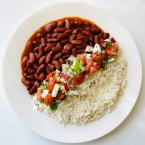 Cooked Rice With tomatoes, dried beans, rice on White Ceramic Plate